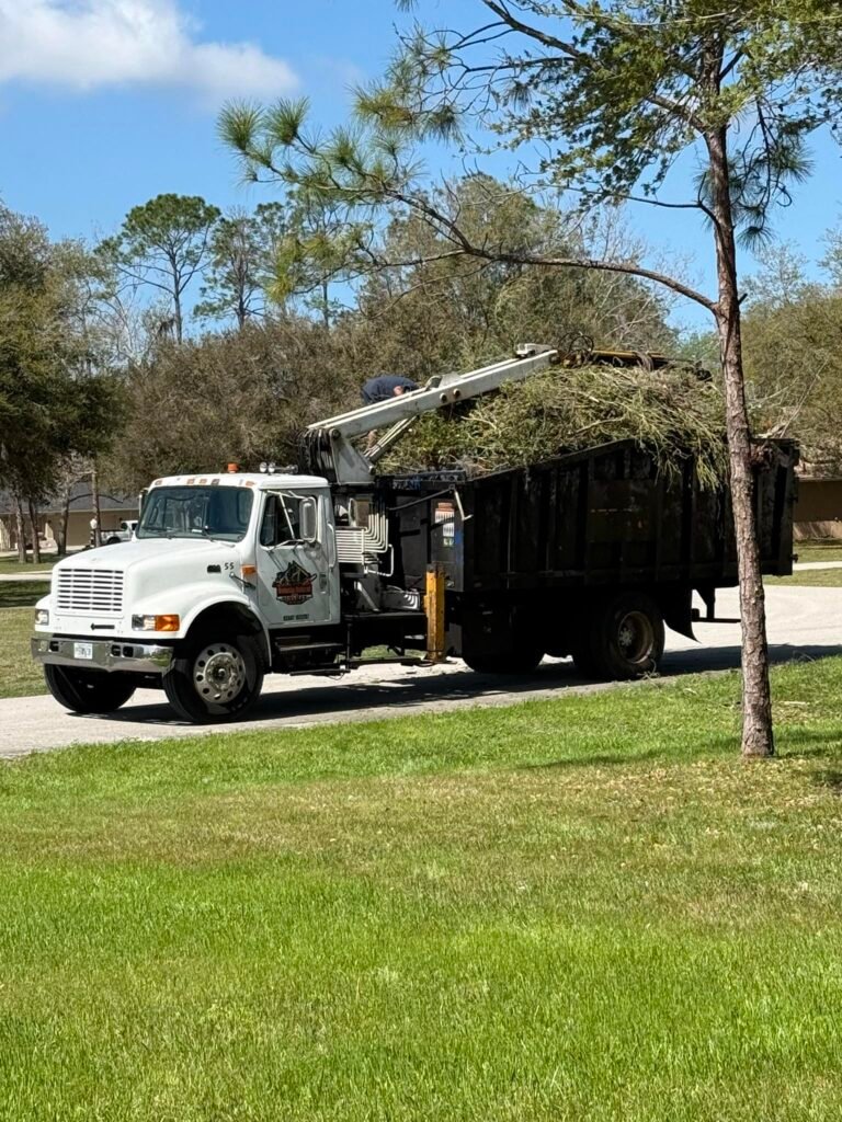Volusia Grapple grapple truck hauling storm debris and brush in Volusia County, Florida.