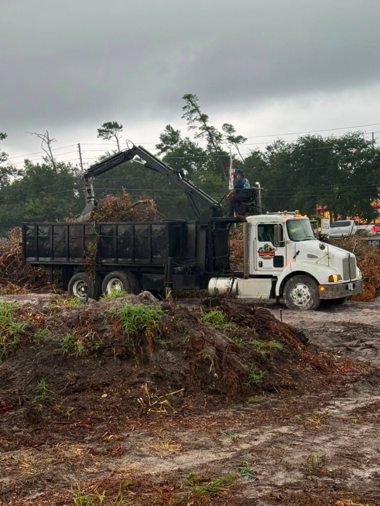 Volusia Grapple grapple truck removing storm debris and tree branches in Volusia County, Florida.